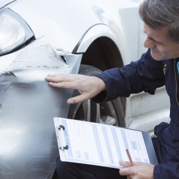 car accident man checking damages report extended car warranty